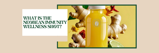 NeoBean Immunity Shot bottle with ginger, turmeric, and mushroom blend ingredients on a clean wood surface.
